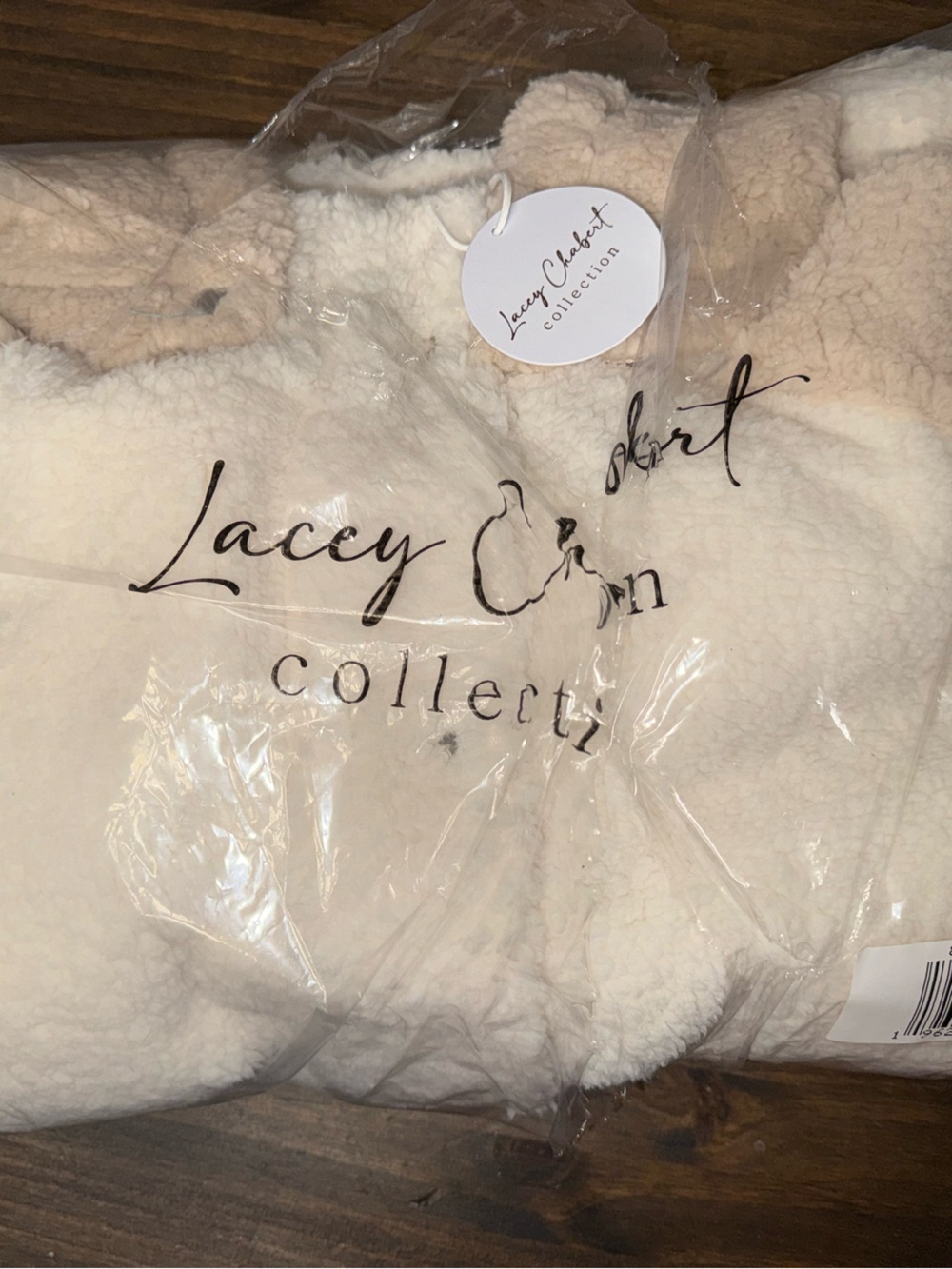 Cream Plush Sherpa sweater with removable hood retails for $80